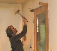 Karl using shims to level a door